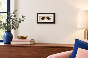 Love Birds framed Irish bog artwork displayed on a wall with a cobalt-blue and blush-pink colour palette.